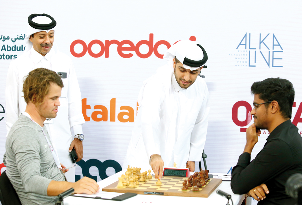 Al Abdulghani Motors CEO Abdulghani Nasser Al Abdulghani makes the first move in the game between Magnus Carlsen and Karthikeyan Murali. Qatar Chess Association President Mohammed Al Madhahka is also present.