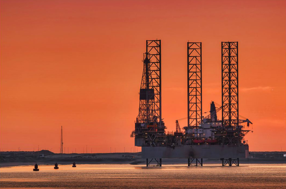 Oil rig is seen at sunset in Rotterdam, Netherlands.