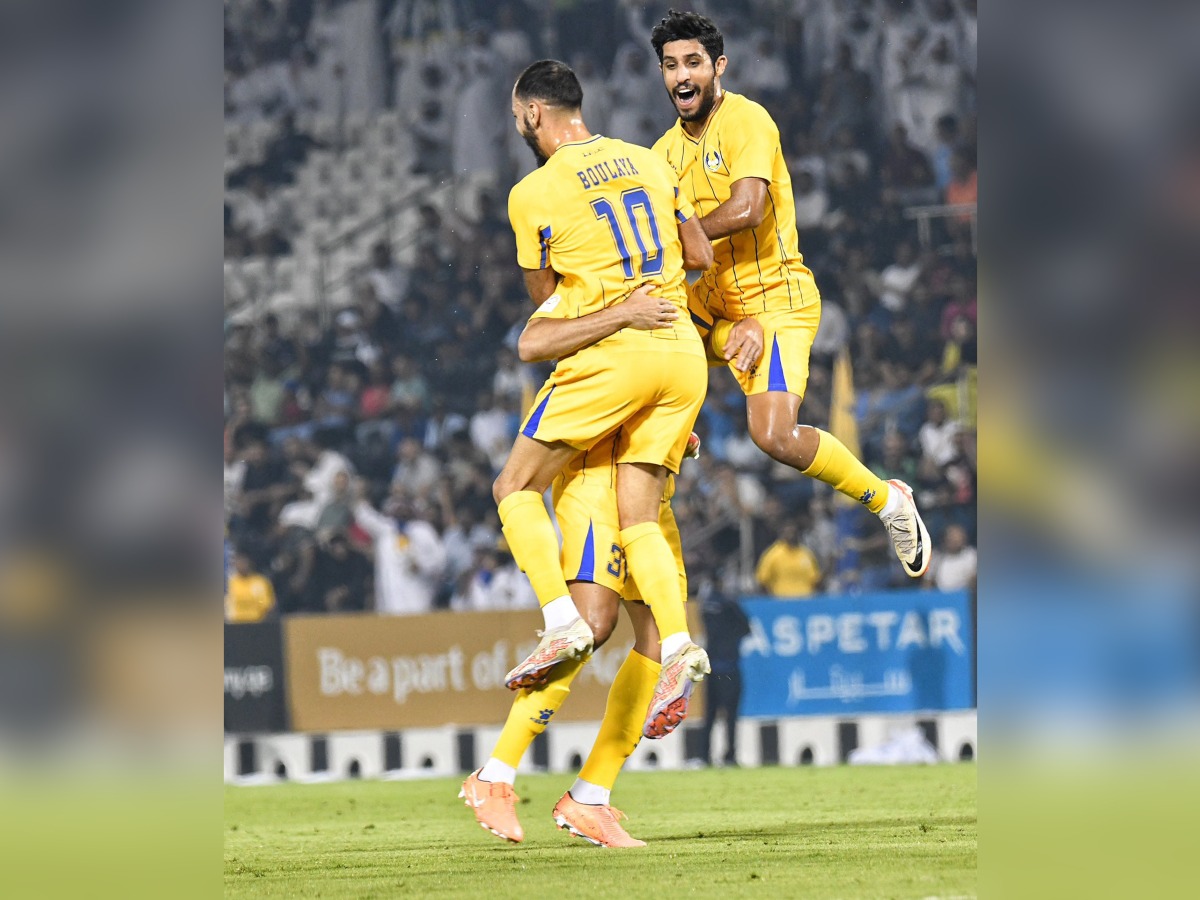 Al Gharafa players celebrate after defeating Al Arabi.