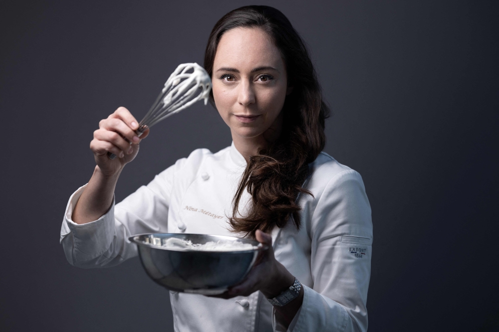 A picture taken on November 6, 2023 shows French World pastry champion Nina Metayer posing at her workshop in Issy-Les-Moulineaux, outside Paris. (Photo by Joel Saget / AFP)