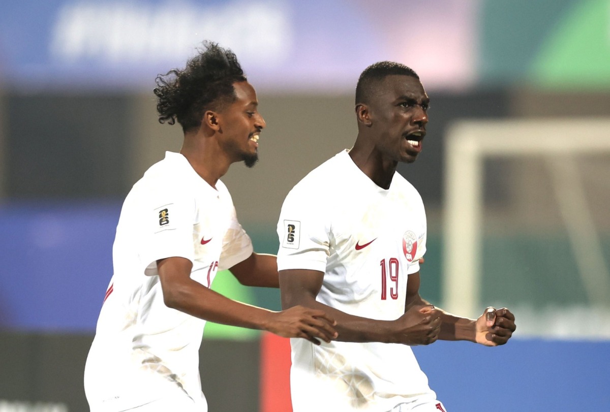 Qatar's Almoez Ali (right) and Yusuf Abdurisag celebrate a goal.