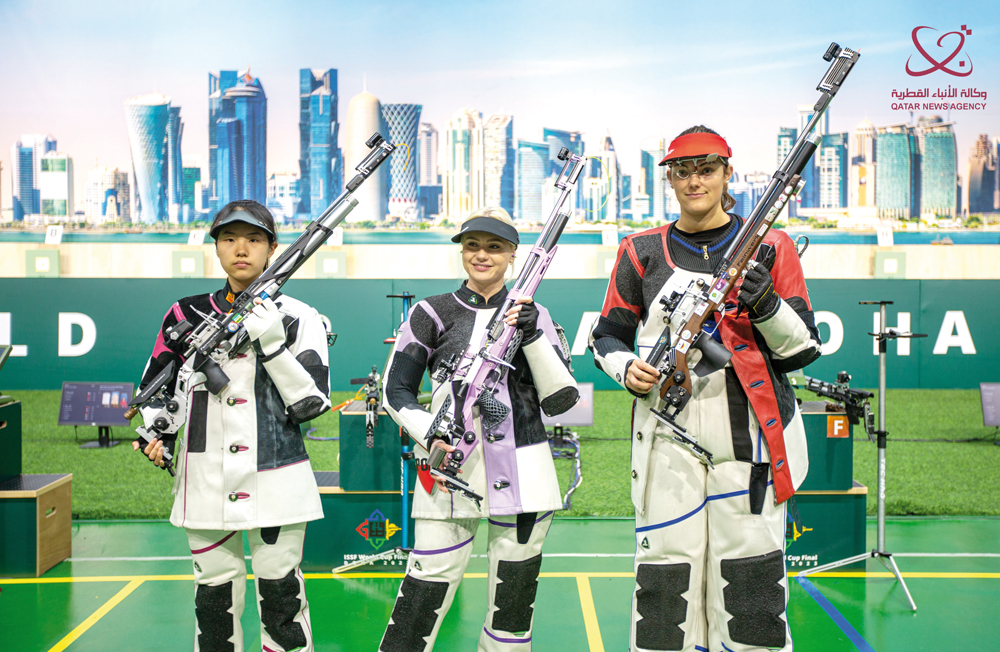 The podium winners of the women's 10m air rifle at the ISSF World Cup Final pose for a photograph.