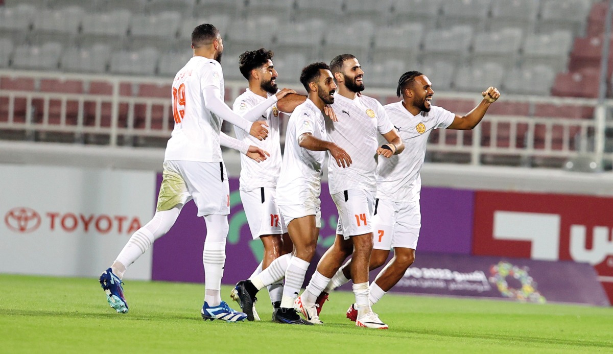 Umm Salal's Oussama Tannane (second right) celebrates with teammates after scoring the goal.