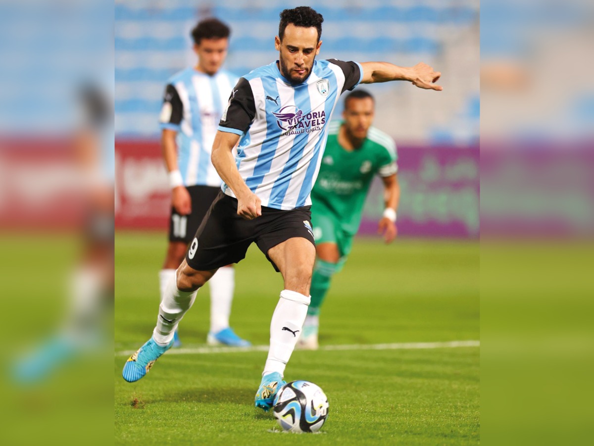 Mohamed Benyettou shoots from the penalty spot to score a goal.