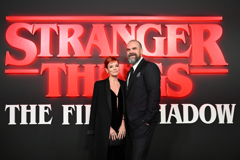 British singer Lily Allen and US actor David Harbour pose on the red carpet upon arrival to attend the West End world premiere of 