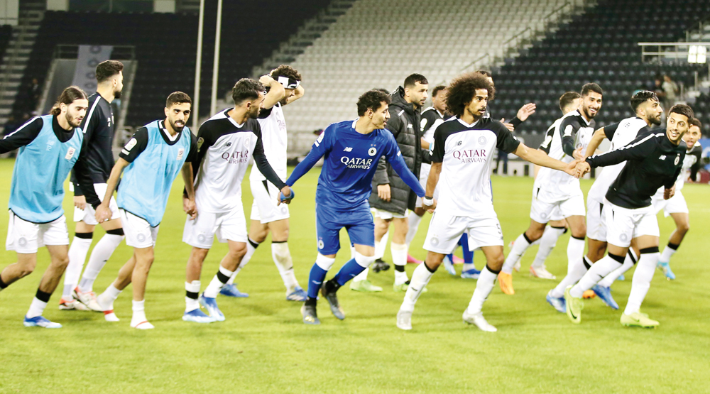 Al Sadd players celebrate after winning a match.