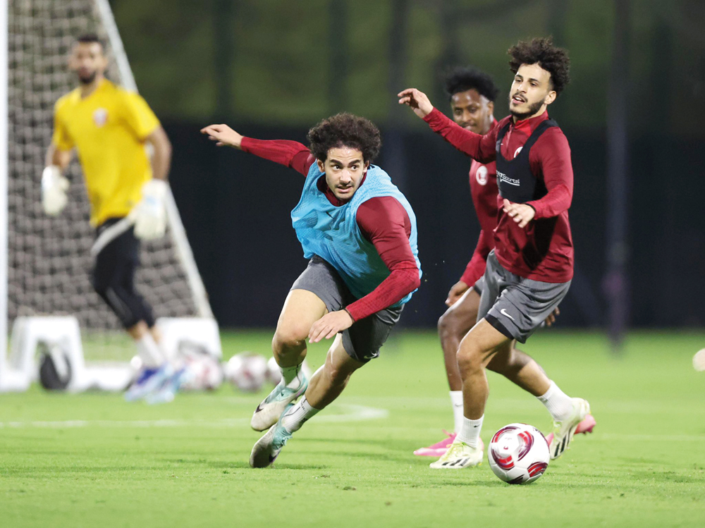 Qatar's Ahmed Alaaeldin (left) trains with teammates. 