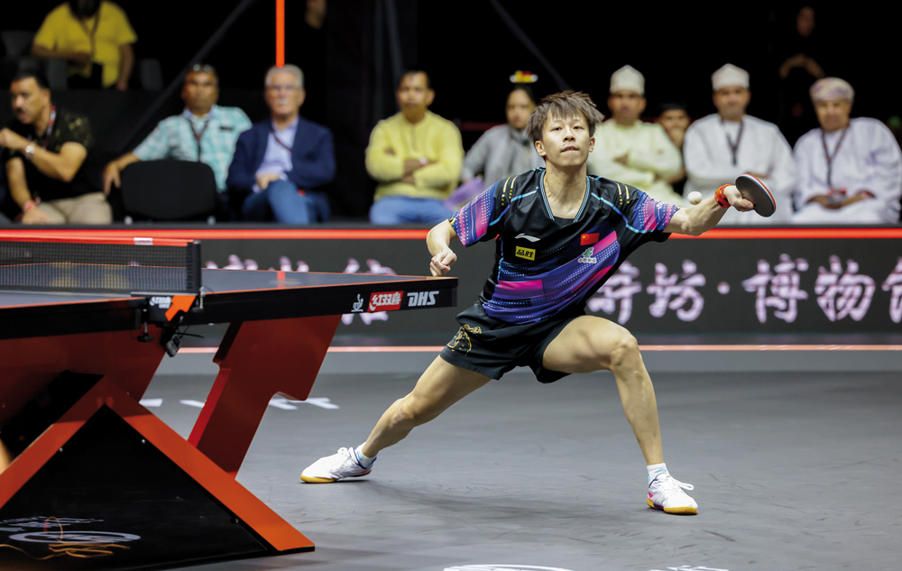 Lin- Gaoyuan hits a shot against Ma Long during yesterday's quarter-final. PIC: WTT