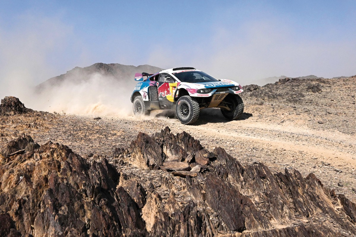 Nasser Racing’s Qatari driver Nasser Al Attiyah and his French co-driver Mathieu Baumel on their car during Stage 2 of the Dakar Rally 2024. AFP