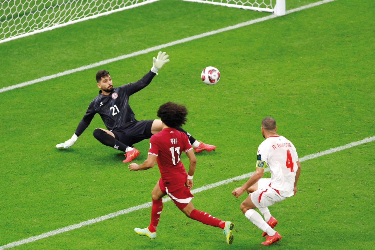 Qatar’s Akram Afif scores his team’s third goal. AFP