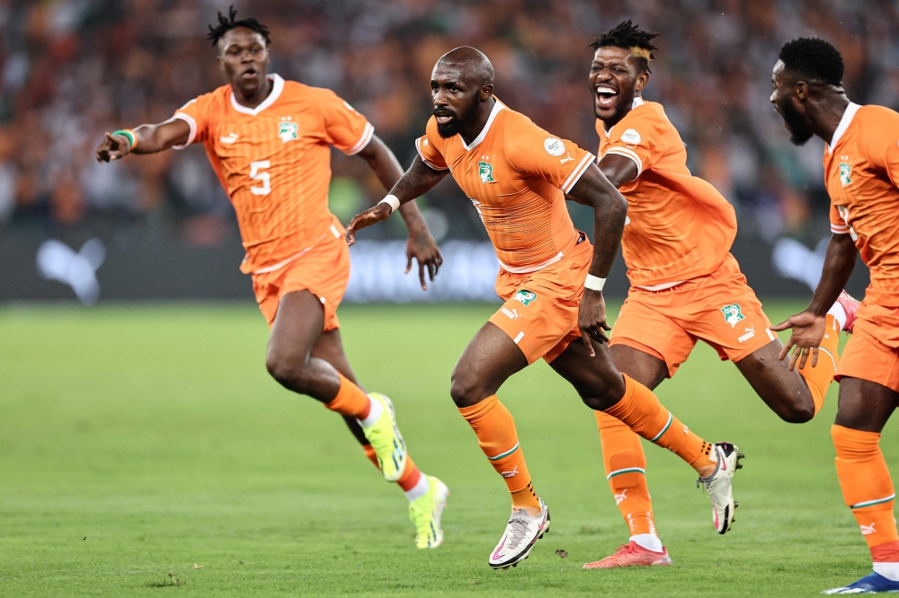 :Ivory Coast's midfielder #6 Seko Fofana (C) celebrates scoring his team's first goal during the Africa Cup of Nations (CAN) 2024 group A football match between Ivory Coast and Guinea-Bissau at the Alassane Ouattara Olympic Stadium in Ebimpe, Abidjan, on January 13, 2024. (Photo by FRANCK FIFE / AFP)