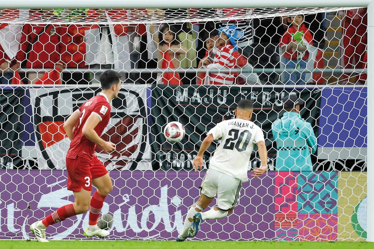 Iraq’s Osama Rashid (right) scores his team’s second goal against Indonesia. AFP