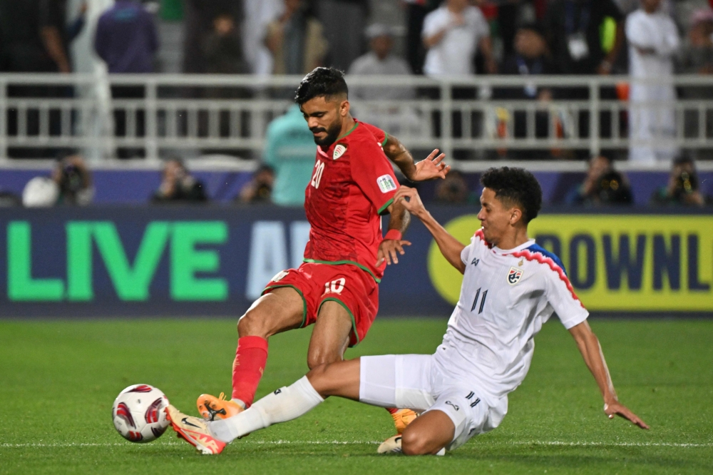 Thailand's midfielder #11 Bordin Phala vies for the ball against Oman's midfielder #20 Salaah al-Yahyaei during the Qatar 2023 AFC Asian Cup Group F football match between Oman and Thailand at the Abdullah bin Khalifa Stadium in Doha on January 21, 2024. (Photo by HECTOR RETAMAL / AFP)