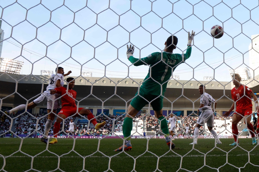 Iraq's forward #18 Aymen Hussein heads the ball to score during the Qatar 2023 AFC Asian Cup Group D football match between Iraq and Vietnam at the Jassim bin Hamad Stadium in Doha on January 24, 2024. (Photo by KARIM JAAFAR / AFP)