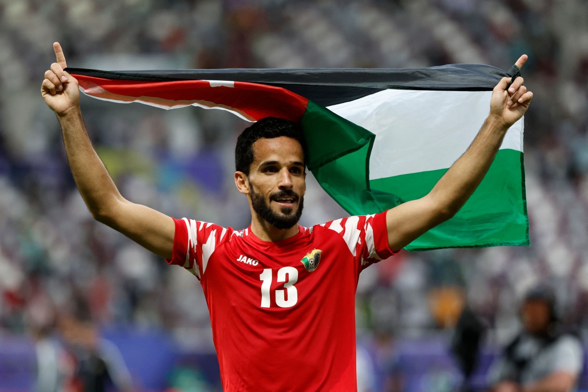 Jordan's players celebrate their team's historic win at the Khalifa International Stadium, yesterday. AFP