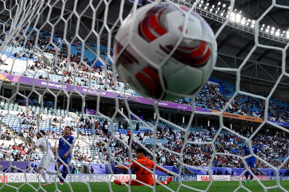 Thailand's goalkeeper #23 Patiwat Khammai concedes the first goal during the Qatar 2023 AFC Asian Cup football match between Uzbekistan and Thailand at Al-Janoub Stadium on January 30, 2024. Photo by KARIM JAAFAR / AFP