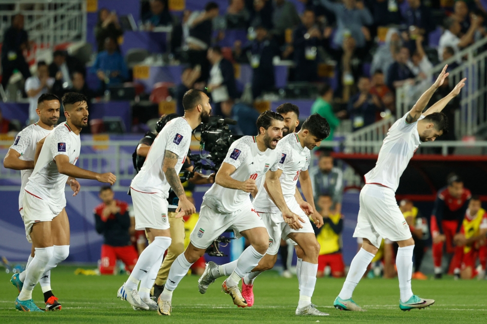 Iran's players celebrate their win at the end of the Qatar 2023 AFC Asian Cup football match between Iran and Syria at the Abdullah bin Khalifa Stadium in Doha on January 31, 2024. (Photo by Karim Jaafar / AFP)