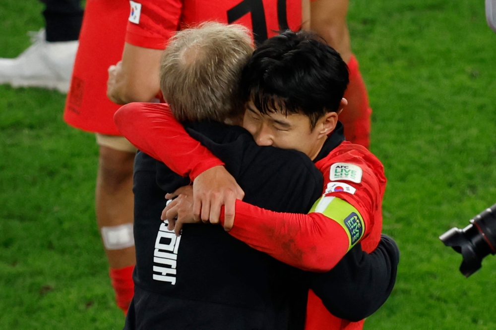 South Korea's midfielder Son Hueng-min celebrates with German coach Jurgen Klinsman after Qatar 2023 AFC Asian Cup quarterfinal match between Australia and South Korea at Al-Janoub Stadium in al-Wakrah, south of Doha. (Karim Jaafar/AFP)
