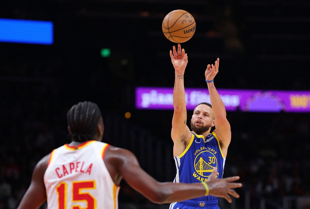 Stephen Curry #30 of the Golden State Warriors attempts a basket against Clint Capela #15 of the Atlanta Hawks during the third quarter at State Farm Arena on February 03, 2024 in Atlanta, Georgia. Kevin C. Cox/Getty Images/AFP 