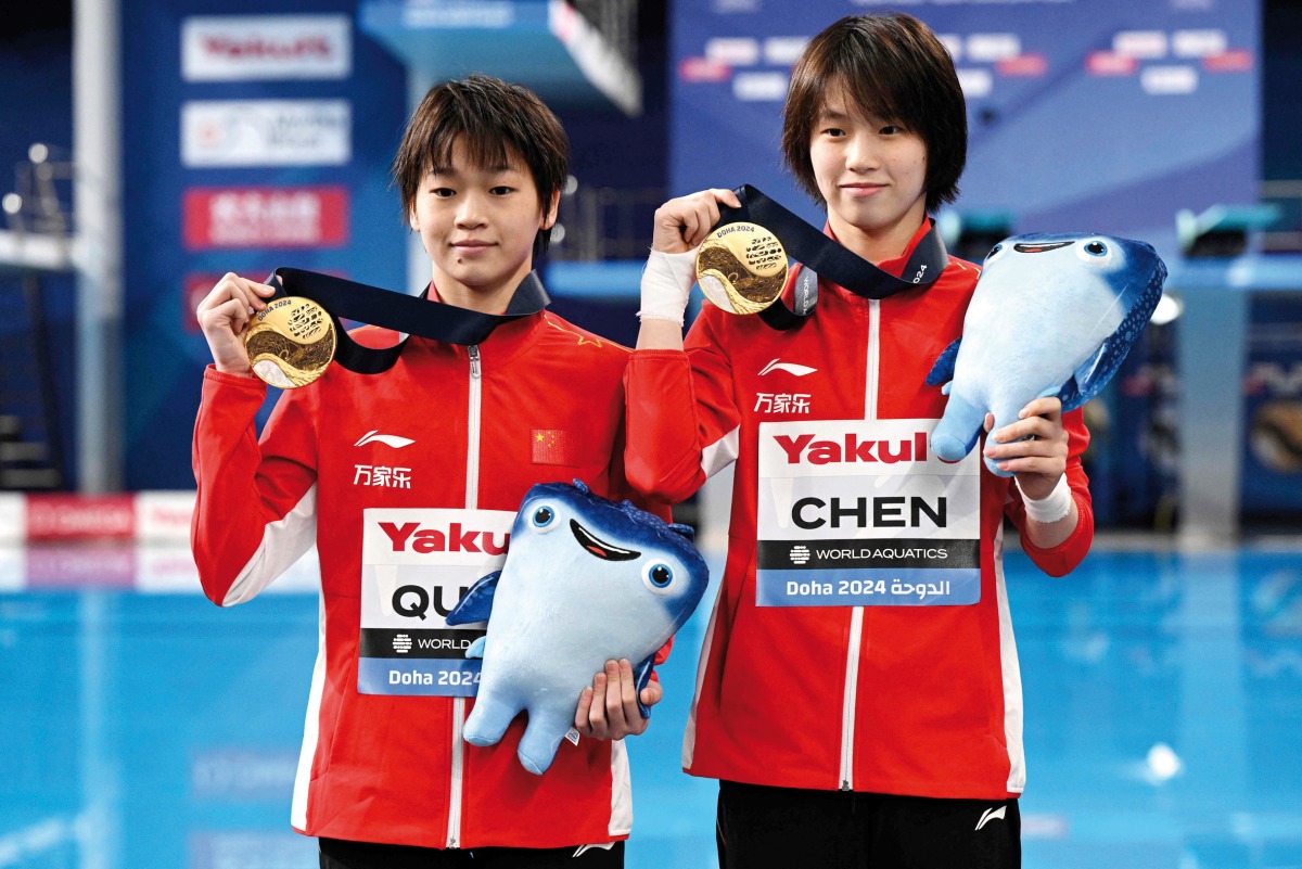 Gold medallists China’s Chen Yuxi and Quan Hongchan pose during the medal ceremony yesterday. AFP