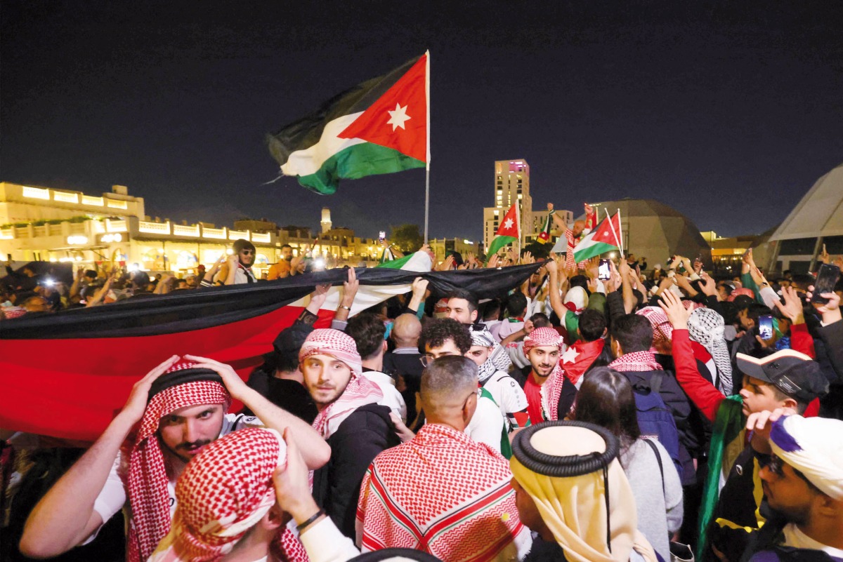 Jordan fans celebrate with national flags after their team reached the final.