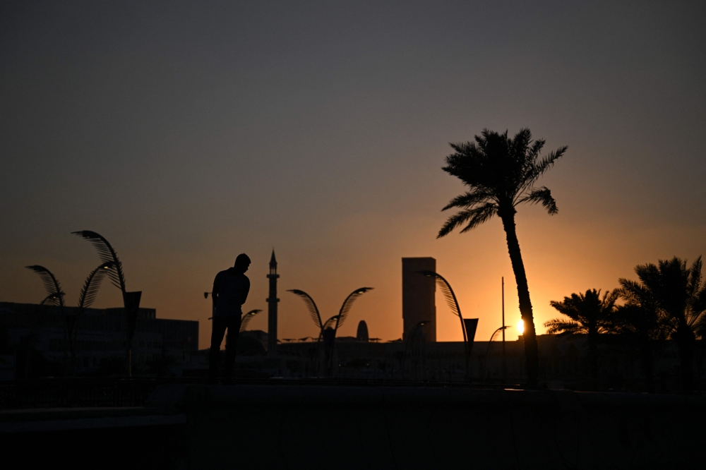 A view of the sun setting over Doha Corniche. (Pic by Hector Retamal/AFP)