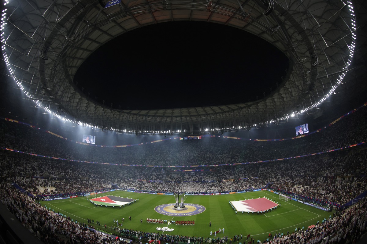 Jordan and Qatar's starting eleven stand up for the national anthems before the start of the Qatar 2023 AFC Asian Cup final football match between Jordan and Qatar at the Lusail Stadium in Lusail, north of Doha on February 10, 2024. Photo by KARIM JAAFAR / AFP
