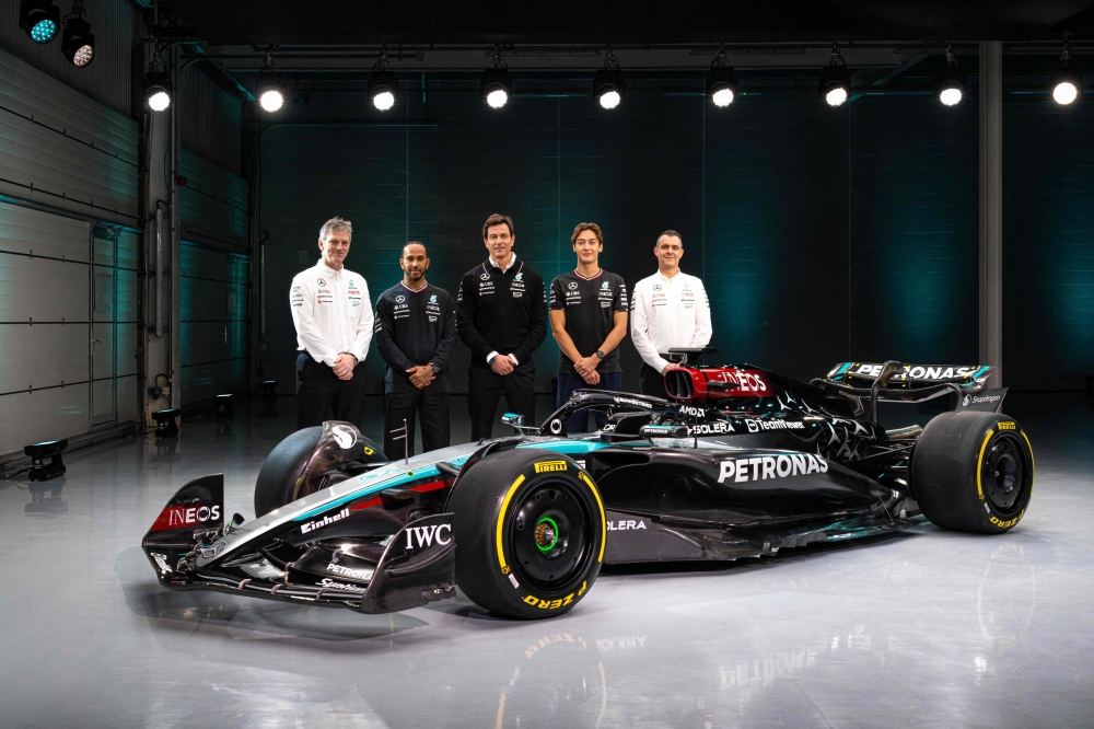 A handout image released by Mercedes on February 14, shows the team's British driver George Russell (2R), Team principal Toto Wolff (C), British driver Lewis Hamilton (2L), Technical Director James Allison (L) and Magaging Director of HPP, Hywel Thomas (R) posing with their new Mercedes-AMG F1 W15 E Performance Formula One racing car during their 2024 season launch, in Silverstone on February 14, 2024. (Photo by MERCEDES / AFP)