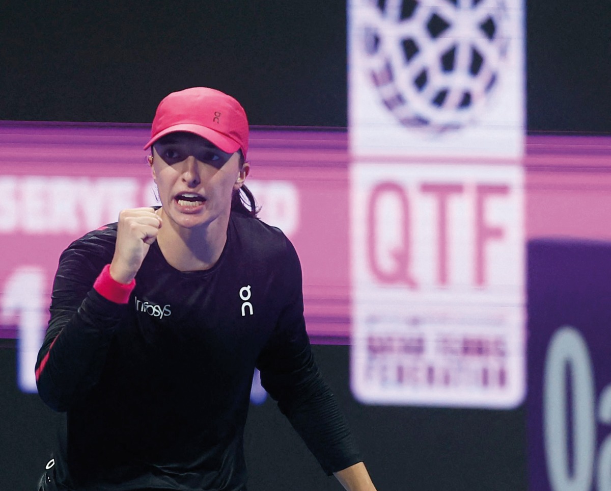 Iga Swiatek of Poland celebrates after scoring a point against Victoria Azarenka of Belarus. 