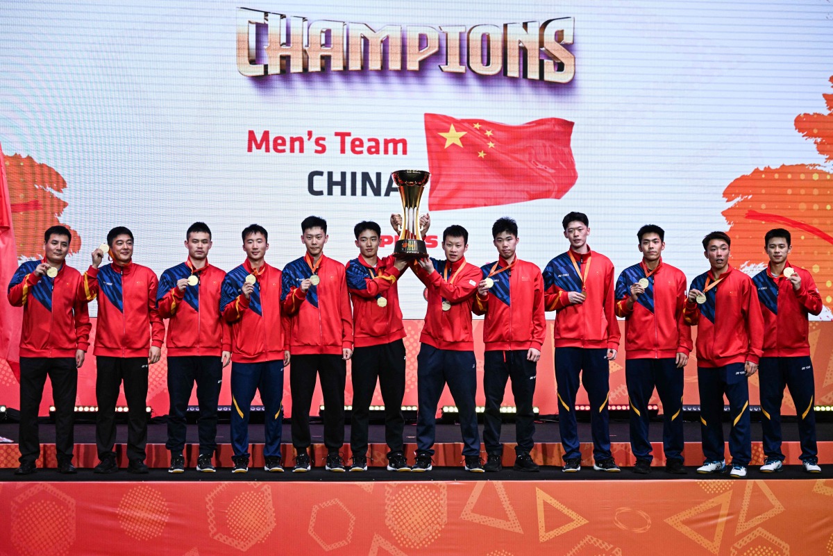 China's men players celebrate with the trophy after winning against Malaysia at the 2024 Badminton Asia Team Championships in Shah Alam, Selangor, on February 18, 2024. (Photo by Mohd RASFAN / AFP)