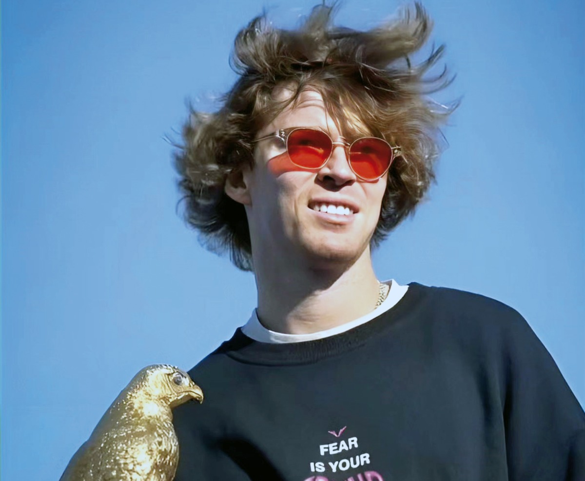 Andrey Rublev holds the Falcon Trophy.  