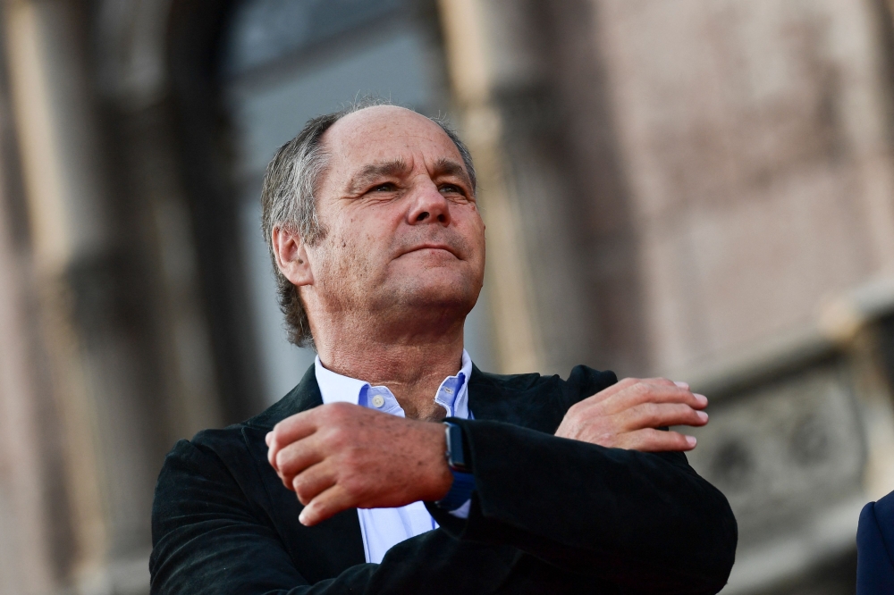 Former Ferrari pilot Austrian Gerhard Berger watches F1 fans gathered in Piazza Duomo in Milan on September 4, 2019 during the presentation of cars and drivers for 90th anniversary of the founding of Scuderia Ferrari. Photo by Miguel MEDINA / AFP