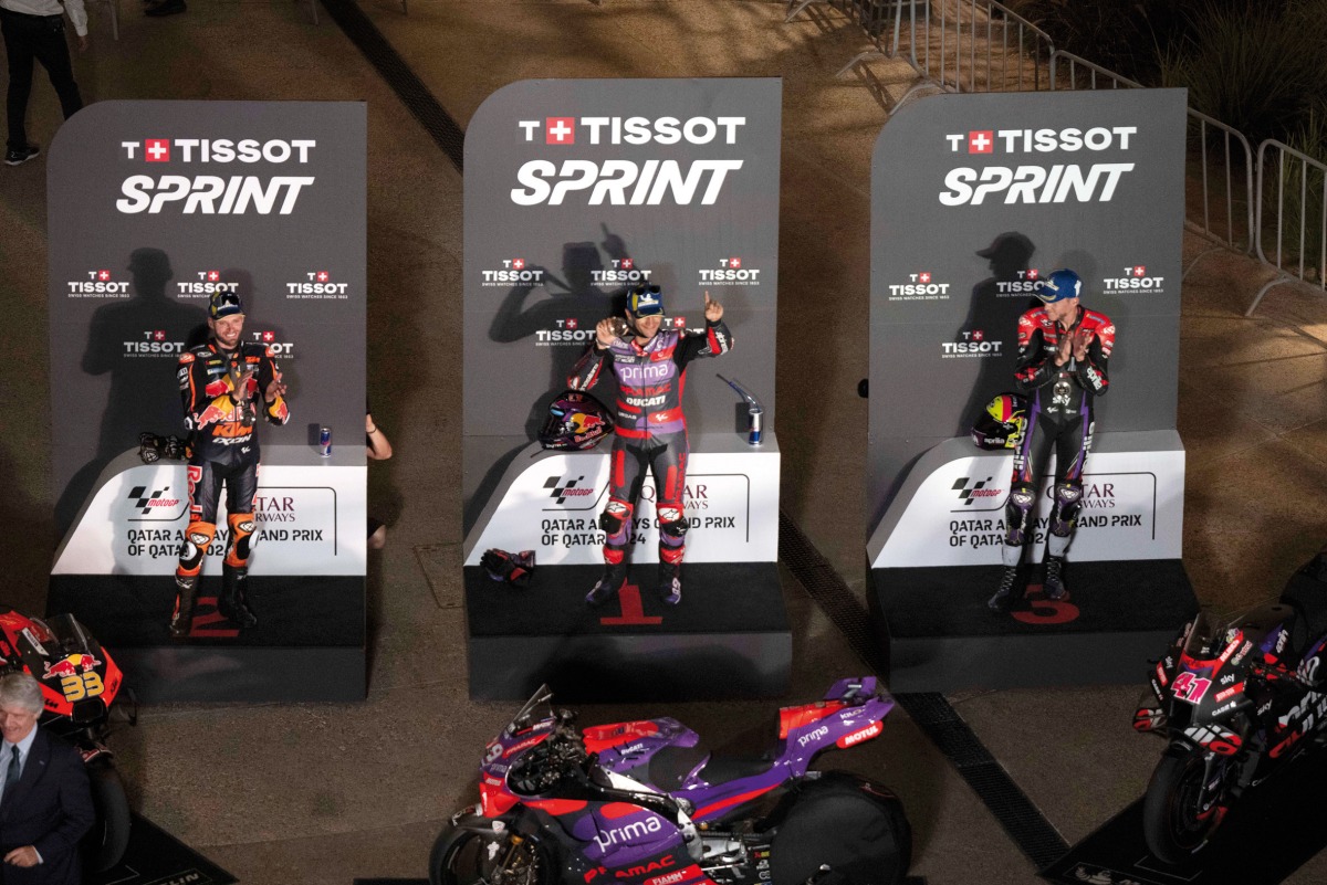 FROM LEFT: Red Bull KTM Factory Racing's South African rider Brad Binder, Prima Pramac Racing's Spanish rider Jorge Martin, and Aprilia Racing's Spanish rider Aleix Espargaro celebrate on the podium after the Qatar Grand Prix MotoGP Sprint at Lusail International Circuit, yesterday. 