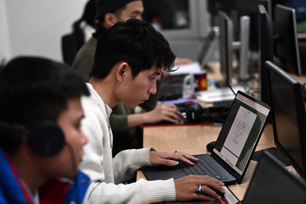 This photo taken on March 1, 2024 shows students at Hanoi University of Science and Technology studying integrated circuit design in a classroom in Hanoi. Photo by Nhac NGUYEN / AFP