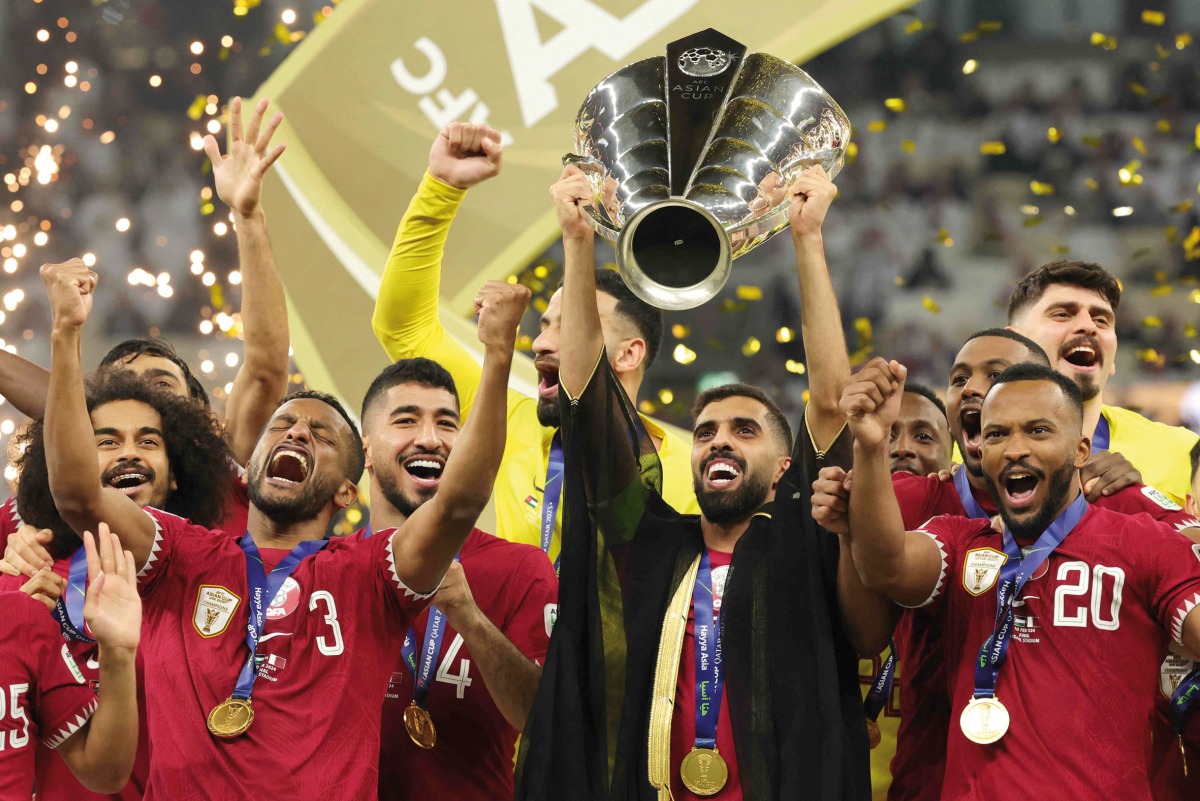 Qatar’s captain Hassan Al Haydos lifts the AFC Asian Cup Qatar 2023 trophy as his team celebrates during the podium ceremony, in this February 10 file photo. AFP