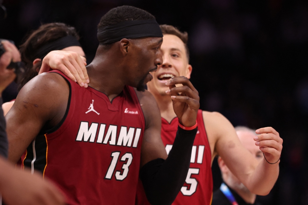 am Adebayo #13 of the Miami Heat celebrates his game winning shot with Duncan Robinson #55 to beat the Detroit Pistons 104-101 at Little Caesars Arena on March 17, 2024 in Detroit, Michigan. (Photo by Gregory Shamus / GETTY IMAGES NORTH AMERICA / Getty Images via AFP)
