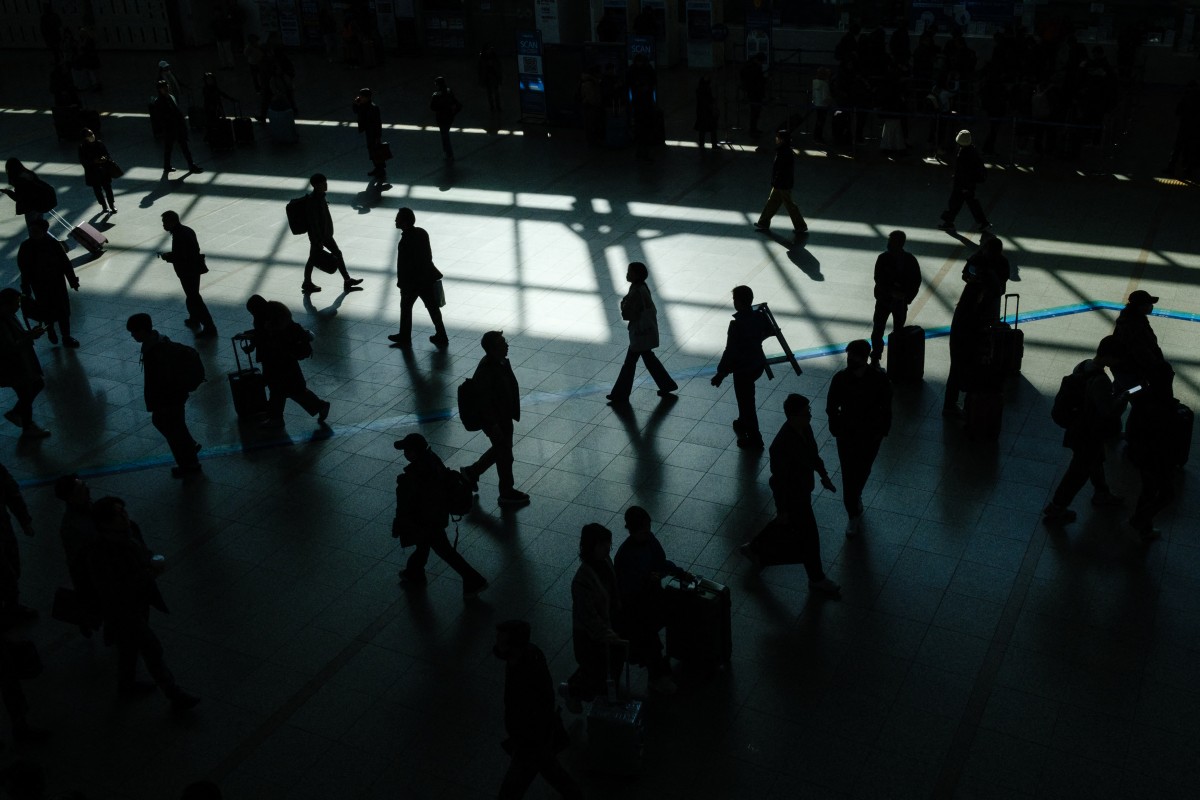 Commuters walk inside a train station in Seoul on March 18, 2024. (Photo by Anthony WALLACE / AFP)