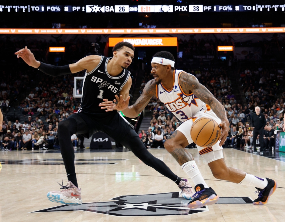 Bradley Beal #3 of the Phoenix Suns drives on Victor Wembanyama #1 of the San Antonio Spurs in the first half at Frost Bank Center on March 23, 2024 in San Antonio, Texas. (Photo by Ronald Cortes / GETTY IMAGES NORTH AMERICA / Getty Images via AFP)
