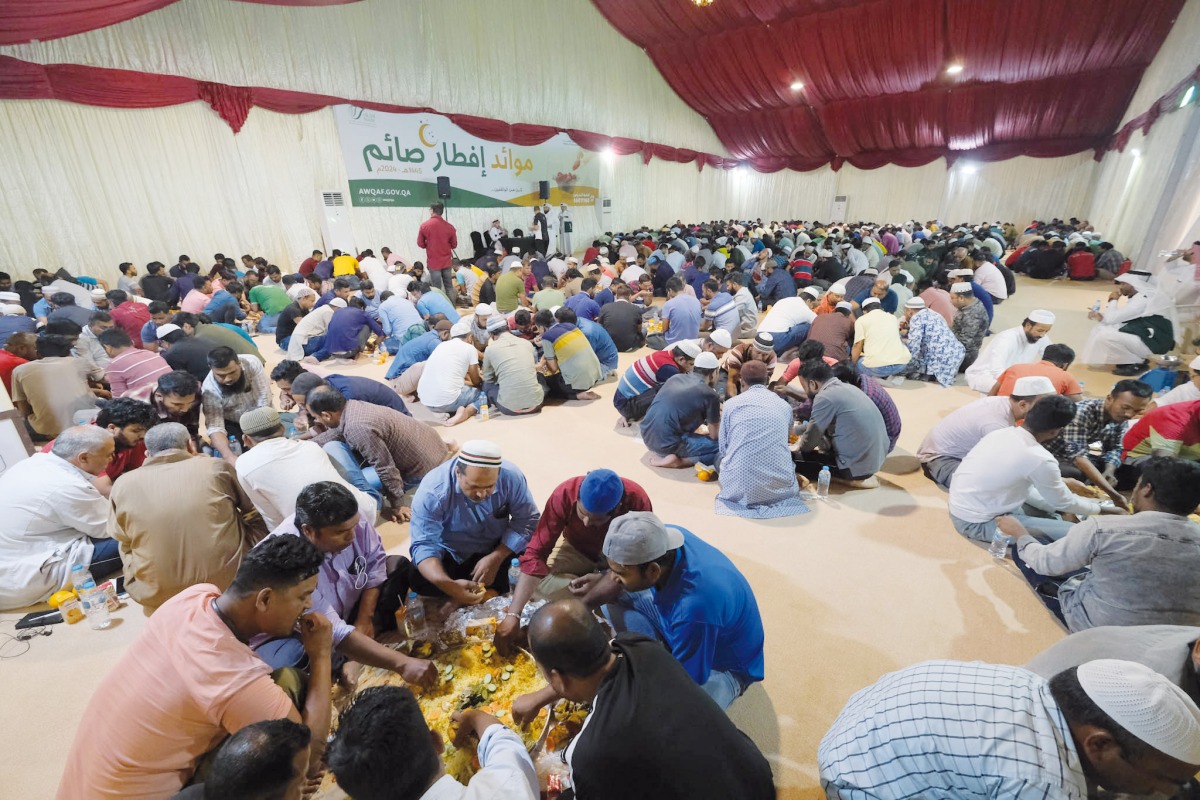 People break their fast at a Ramadan tent in Al Muraikh.