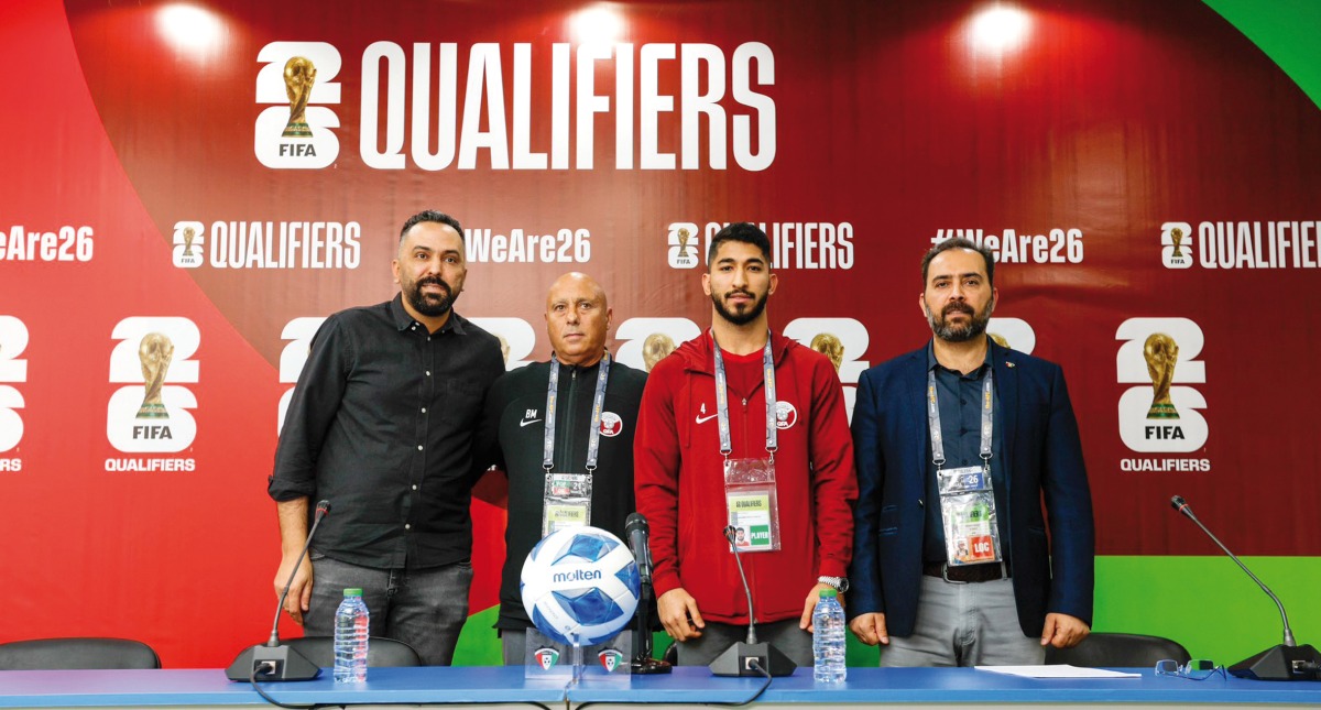 Qatar coach Marquez Lopez (second left) and midfielder Mohammed Waad (second right) pose for a photo after the press conference.