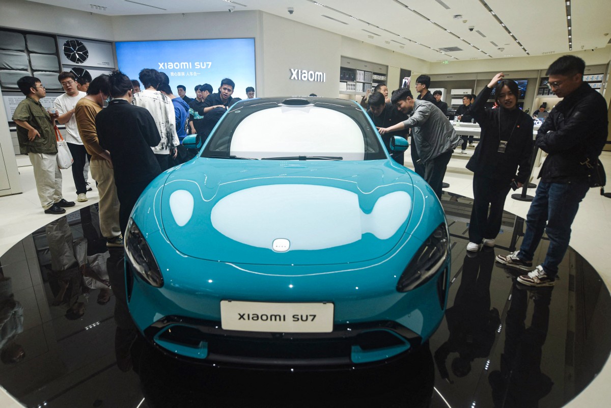 Chinese smartphone maker Xiaomi's first electric car, Xiaomi SU7 model, is seen at a shop in Hangzhou, in eastern China's Zhejiang province on March 25, 2024. (Photo by AFP)
