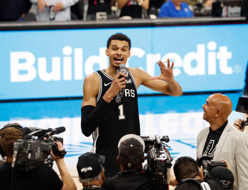 Victor Wembanyama #1 of the San Antonio Spurs address the crowd after they defeated the New York Knicks at Frost Bank Center on March 29, 2024 in San Antonio, Texas. (Photo by Ronald Cortes / GETTY IMAGES NORTH AMERICA / Getty Images via AFP)
