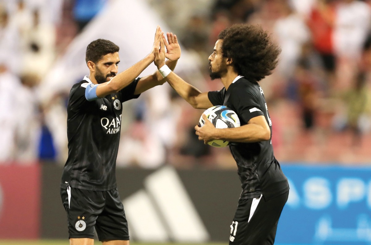 Al Sadd's captain Hassan Al Haydos congratulates Akram Afif after the latter scored their first goal.