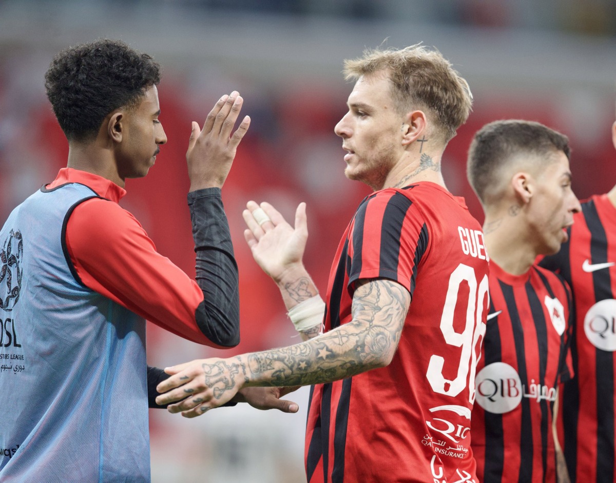 Al Rayyan's Roger Guedes (centre) celebrates with teammates after the match.