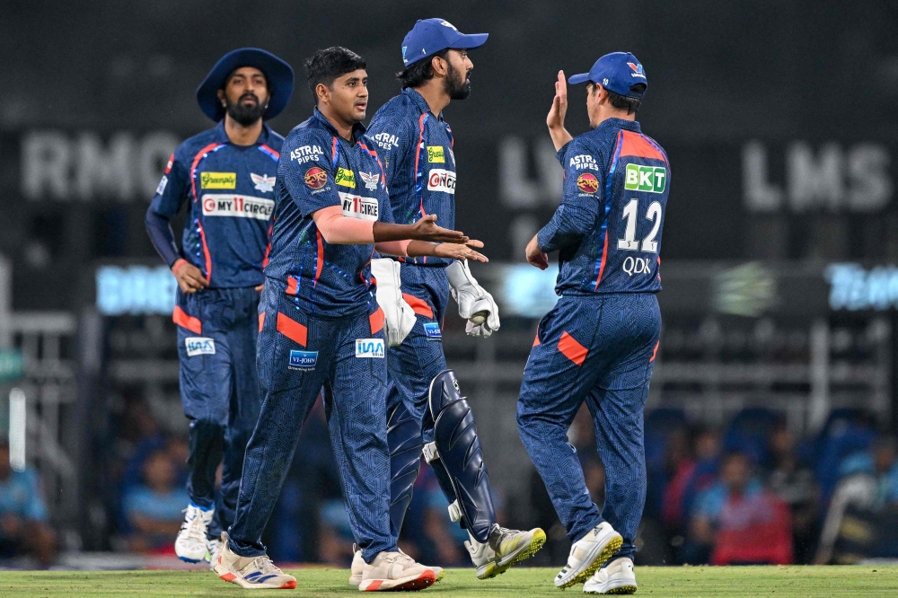 Lucknow Super Giants' Yash Thakur (2L) celebrates with teammates after taking the wicket of Gujarat Titans' Vijay Shankar during the Indian Premier League (IPL) Twenty20 cricket match between Lucknow Super Giants and Gujarat Titans at the Ekana Cricket Stadium in Lucknow on April 7, 2024. (Photo by Sajjad HUSSAIN / AFP)
