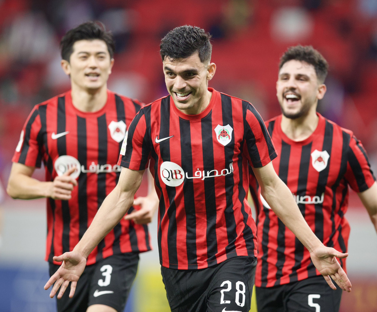 Al Rayyan's Achraf Bencharki (centre) celebrates with teammates after scoring the goal against Muaither yesterday. 