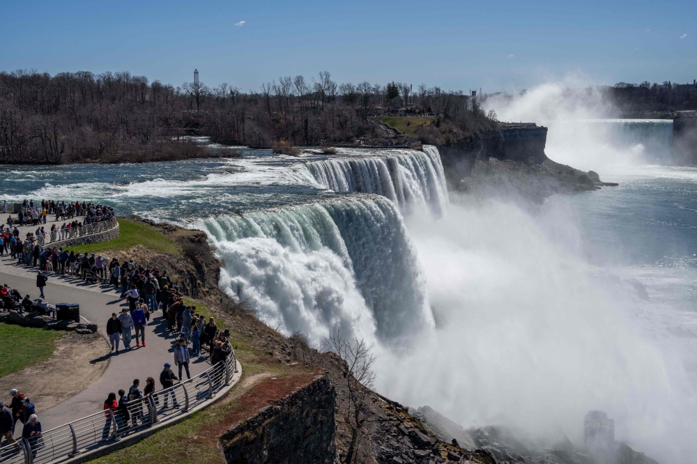 People visit Niagara Falls on the day ahead of the eclipse on April 7, 2024, in Niagara Falls, New York. Adam Gray/Getty Images/AFP 