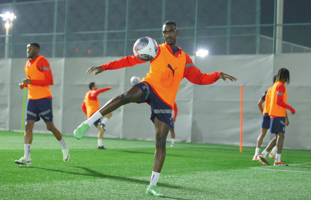 Al Duhail's Almoez Ali (centre) trains with teammates.