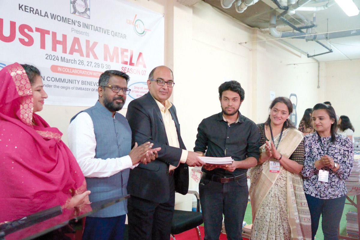 Ambassador of India to Qatar, H E Vipul (third left) with other officials and beneficiaries during the event.