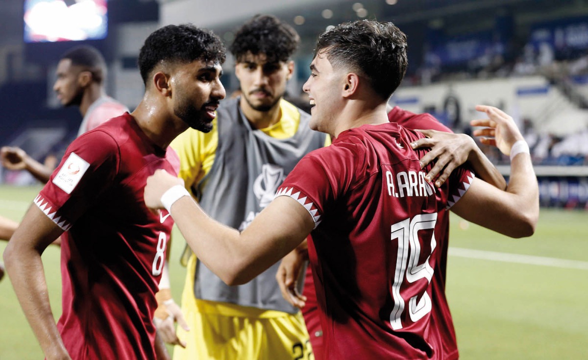 Qatar's Ahmed Al Rawi celebrates with team-mates after scoring the team's second goal against Indonesia yesterday.  Pics: Rajan Vadakkemuriyil / The Peninsula